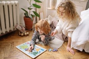 Mother and Son Sitting on the Floor, playing jigsaw puzzle