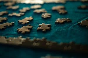 close up of jigsaw pieces on a blue table